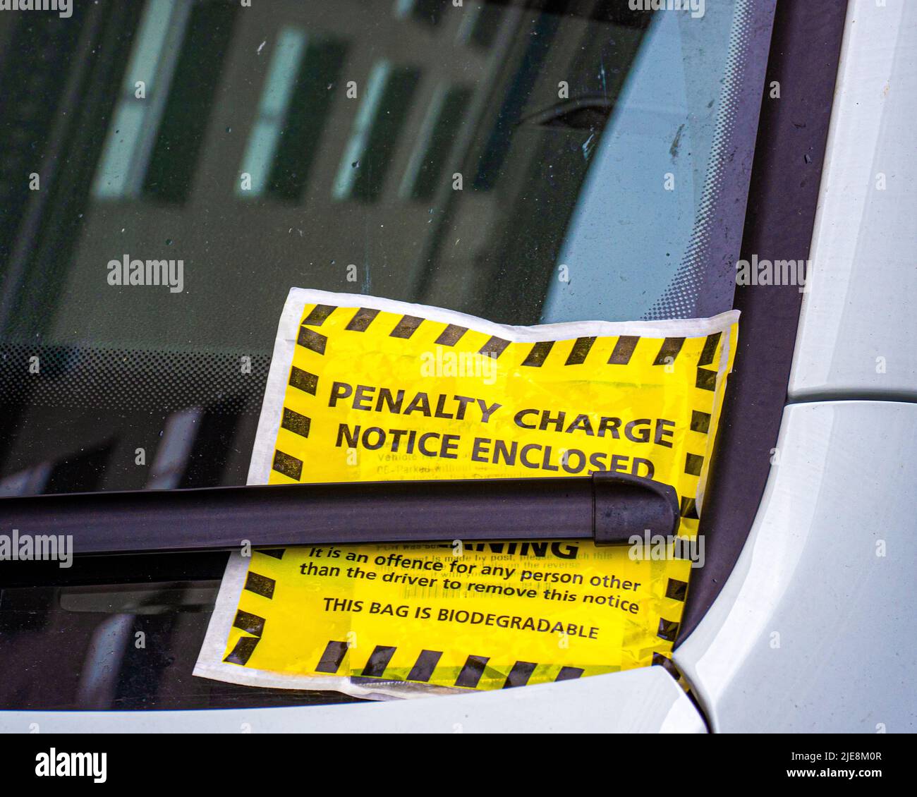Close up of parking ticket placed under windshield wiper of a car Stock Photo