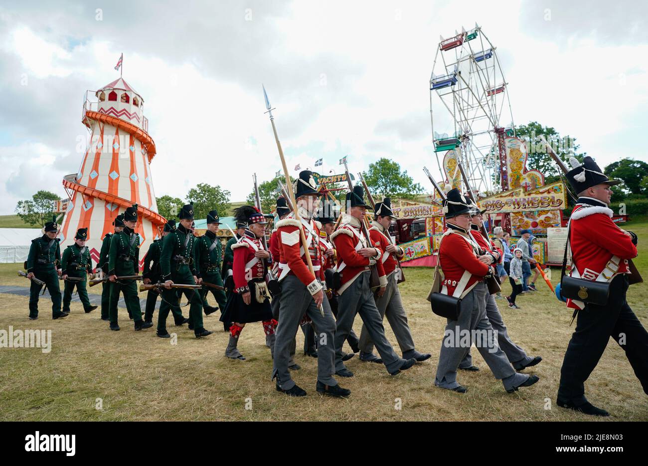 Members of the 4th King's Own Regiment of Foot and 2nd Battalion 9th Rifles parade around the festival ground during the Chalke Valley History festival at Broad Chalke, Near Salisbury, Wiltshire. Picture date: Sunday June 26, 2022. Stock Photo
