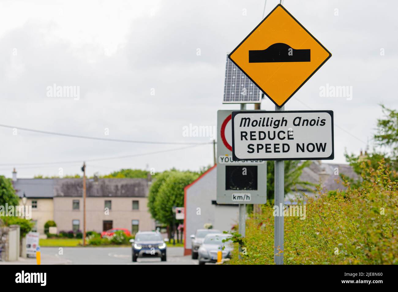 Roadsign advising drivers of the presence of speed humps, and to reduce speed now, Republic of Ireland Stock Photo