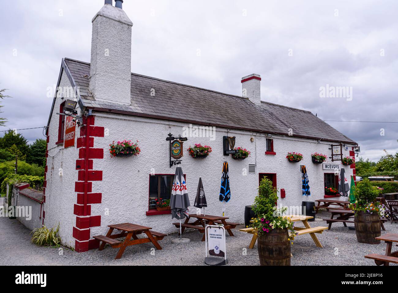 Pretty, traditional Irish rural pub, with picnic tables outside. Stock Photo