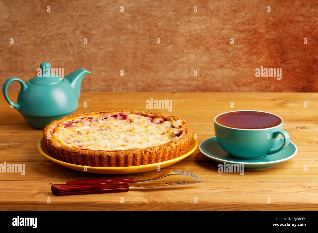 Homemade berry pie and cup of tea on wooden table. Copyspace. Stock Photo