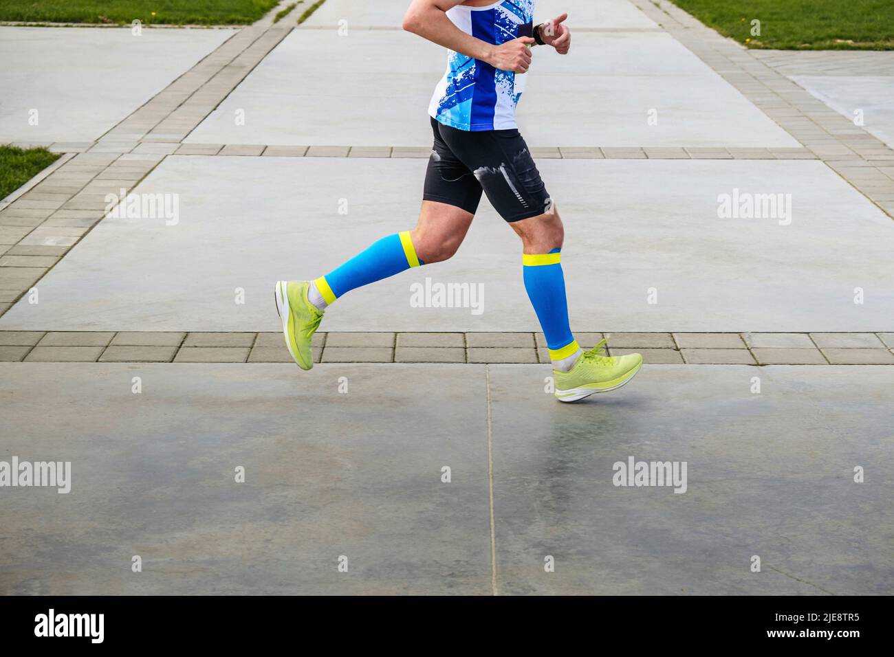 male runner in legs sleeves run marathon Stock Photo