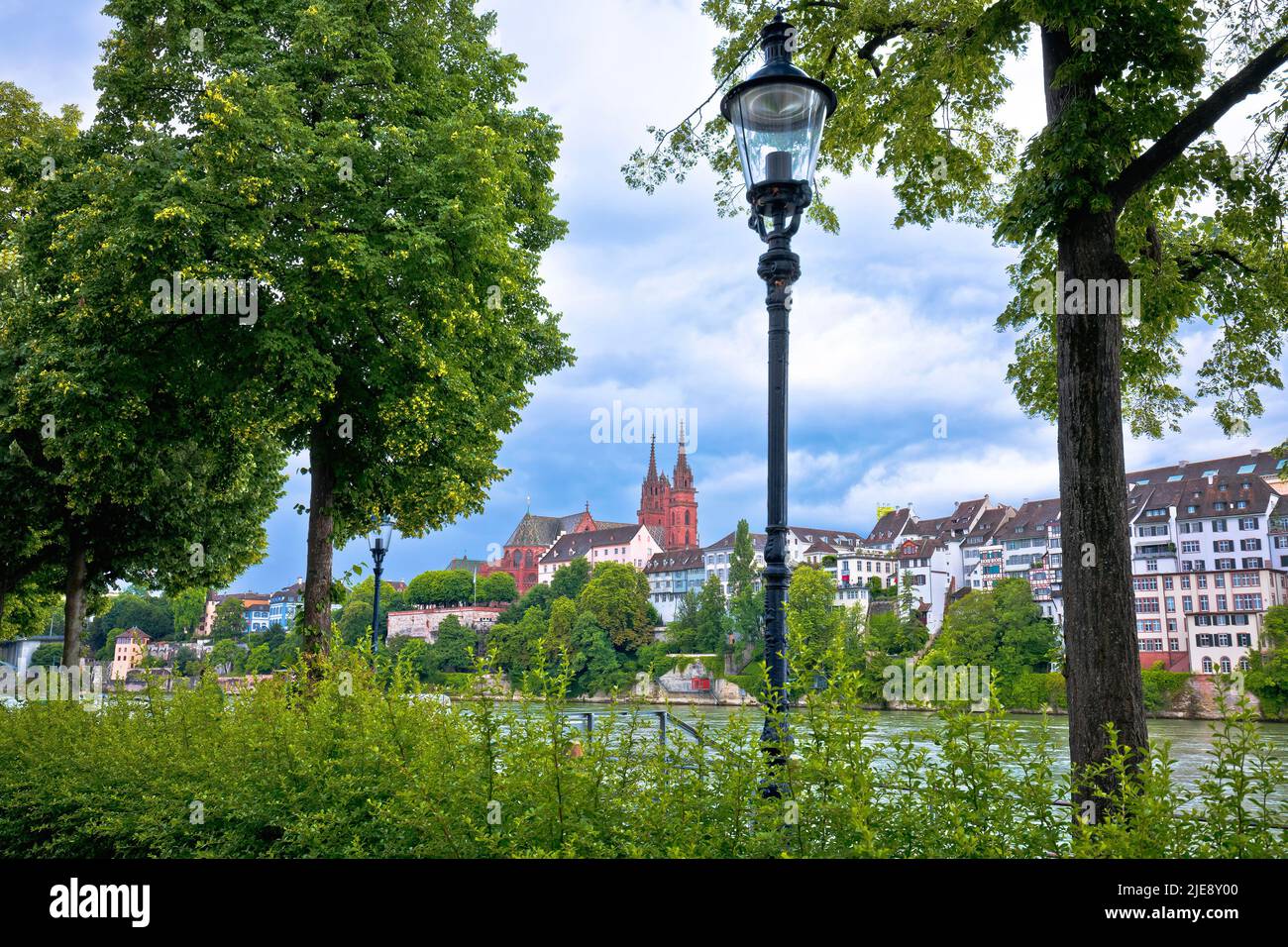 Rhine river green waterfront and Basel Minster view, northwestern Switzerland Stock Photo