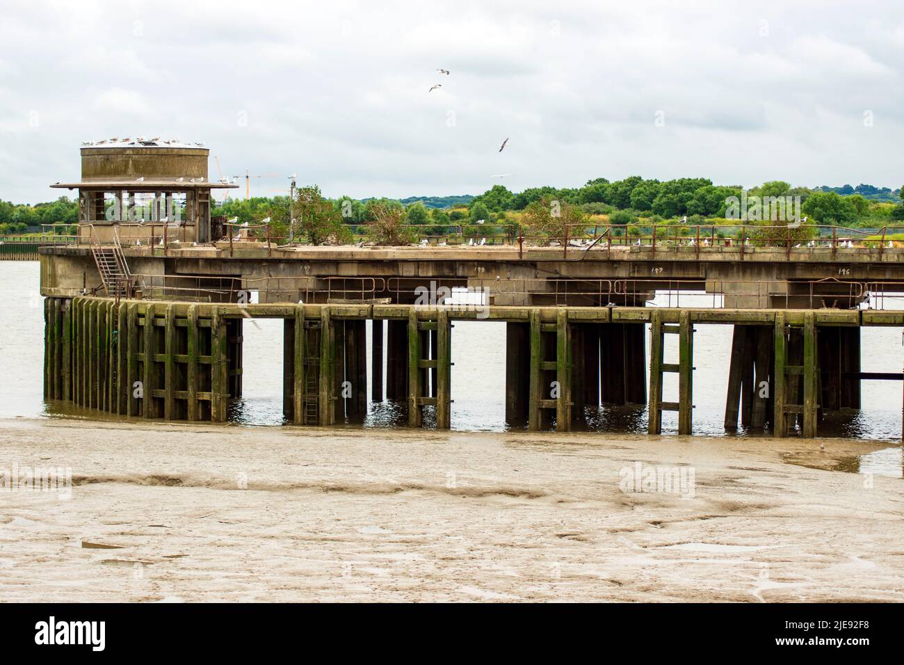 Derelict and abandoned coal jetty in the River Thames, part of the now demolished Beckton Gasworks in Newham, East London, UK. Stock Photo