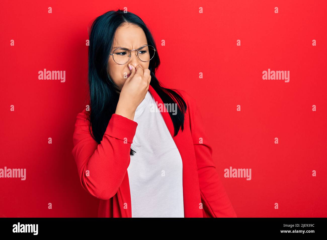 Beautiful hispanic woman with nose piercing wearing casual look and