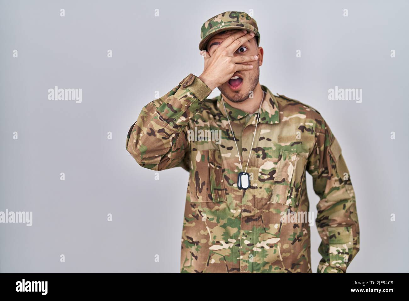 Young hispanic man wearing camouflage 