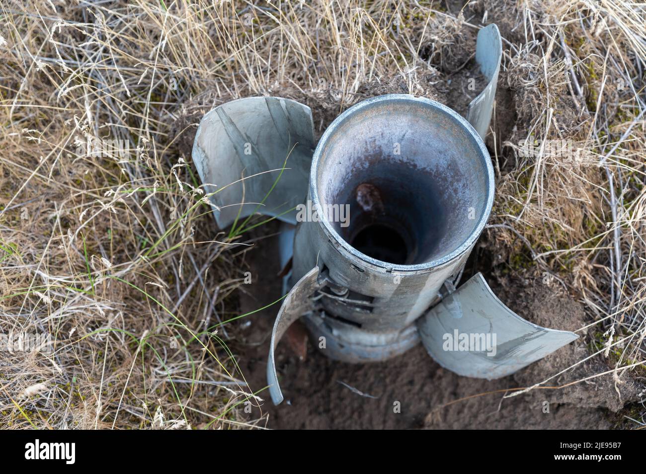 BM-30 Smerch missile stuck in the ground. A rocket was fired by the Russian army at a Ukrainian city. Russian war against Ukraine. Genocide of the Ukr Stock Photo
