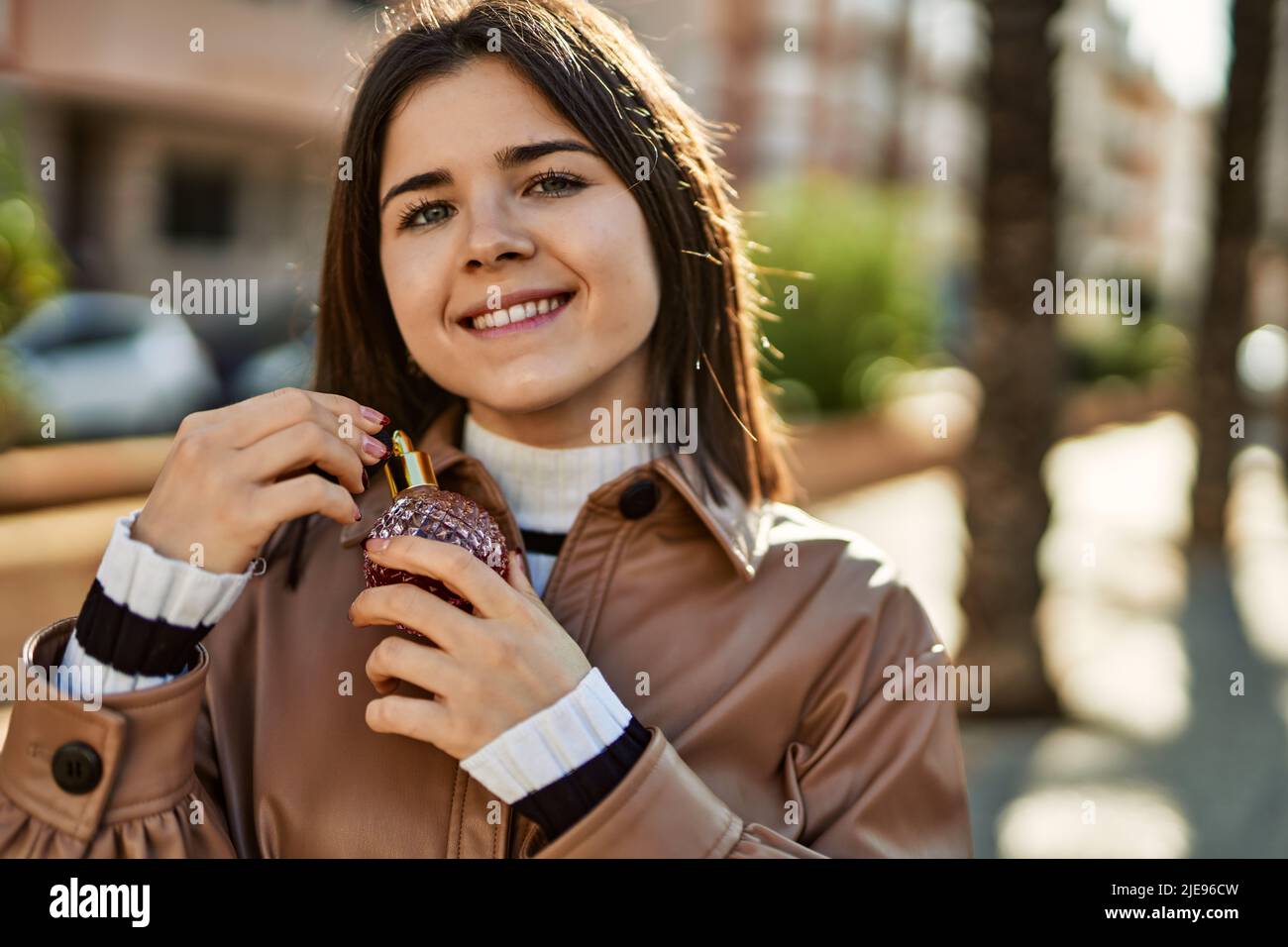 Young beautiful brunette woman smiling happy outdoors Stock Photo - Alamy