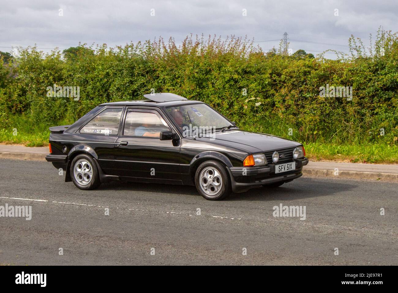 1982 80s, eighties Ford Escort Xr3 black petrol Hatchback; Antique classic cars, motorcycles, light trucks, ex-army vehicles, and vintage 4x4s are arriving at Hoghton Tower for the Supercar Summer Showtime car meet which is organised by Great British Motor Shows. Stock Photo