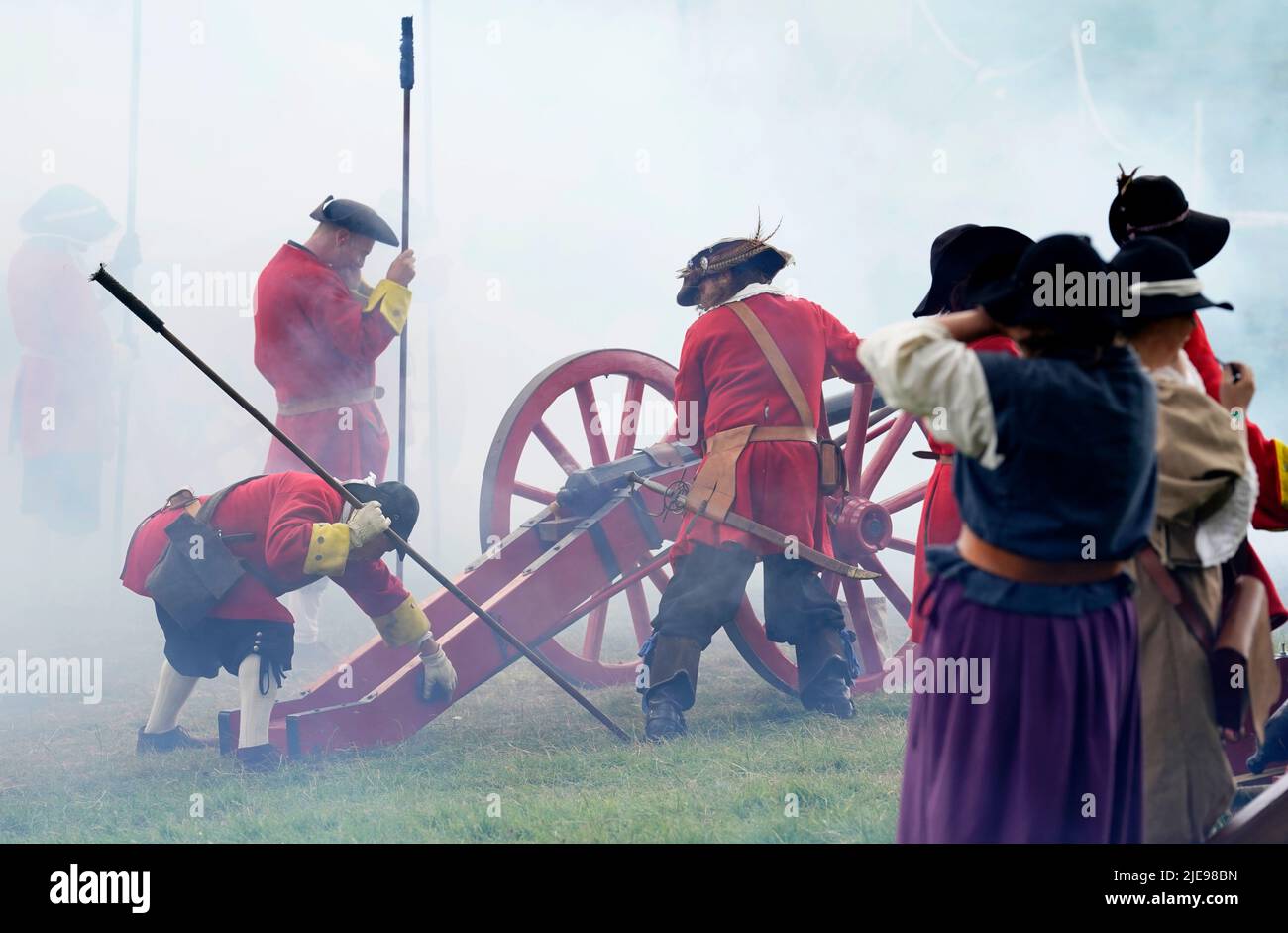 Members of the Wimborne Militia fire their guns during a siege warfare demonstration during the Chalke Valley History festival at Broad Chalke, Near Salisbury, Wiltshire. Picture date: Sunday June 26, 2022. Stock Photo