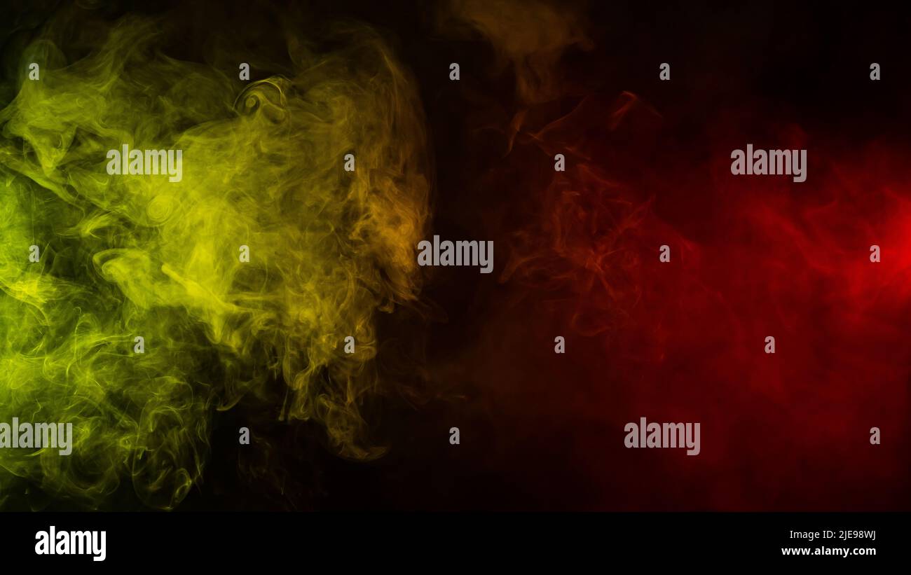 Red-yellow smoke spreads on a black background Stock Photo - Alamy
