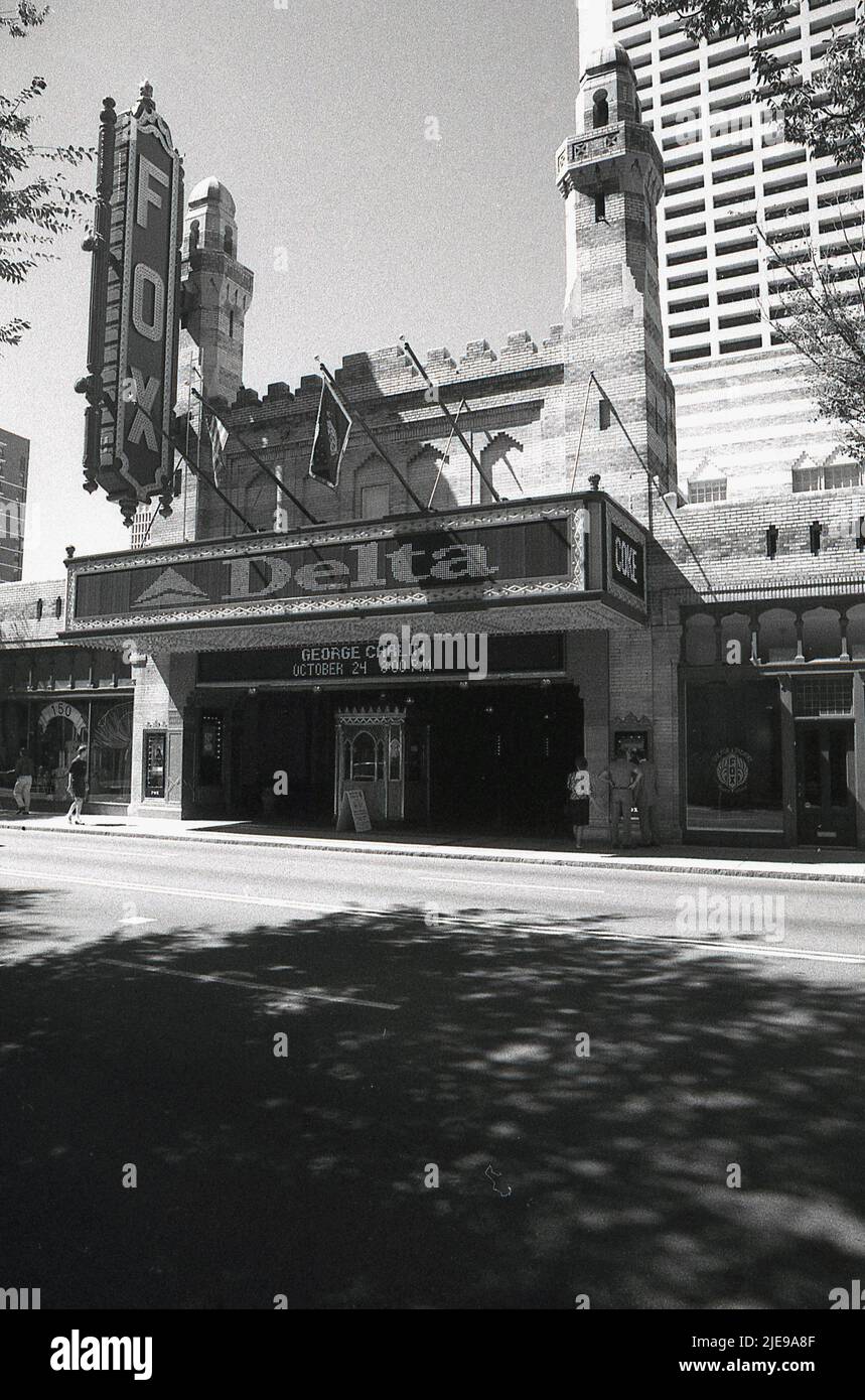 The building on Peachtree Street NE, in Midtown Atlanta, Georgia was originally designed as a Shrine Temple but opened in 1929 as a movie palace. In the 1970s it was saved from demolition and became a performing arts venue  At this time, the famous American stand-up comedian George Carlin is billed to be appearing there. On the front of the building, an advertisement for Delta Air Lines, whose headquarters are in Atlanta. Stock Photo