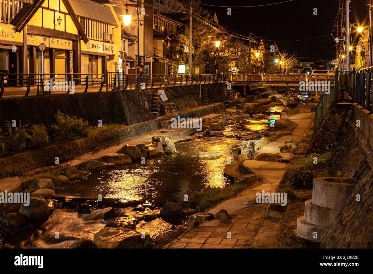Illuminated Tamatsukuri Onsen cityscape and Tamayugawa River at night. Tamatsukuri town is known as historical hot spring resort in Matsue. Stock Photo