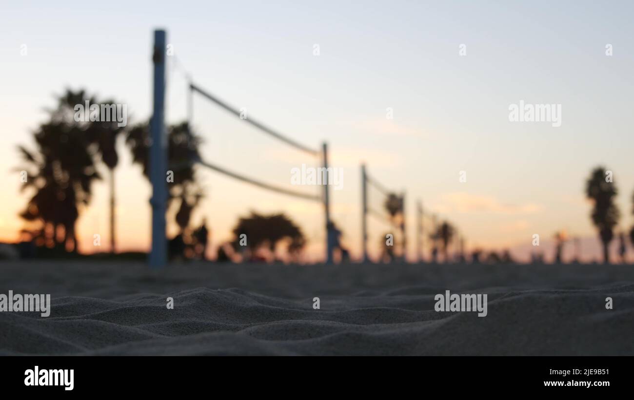 Players playing volleyball on beach court, volley ball game with ball