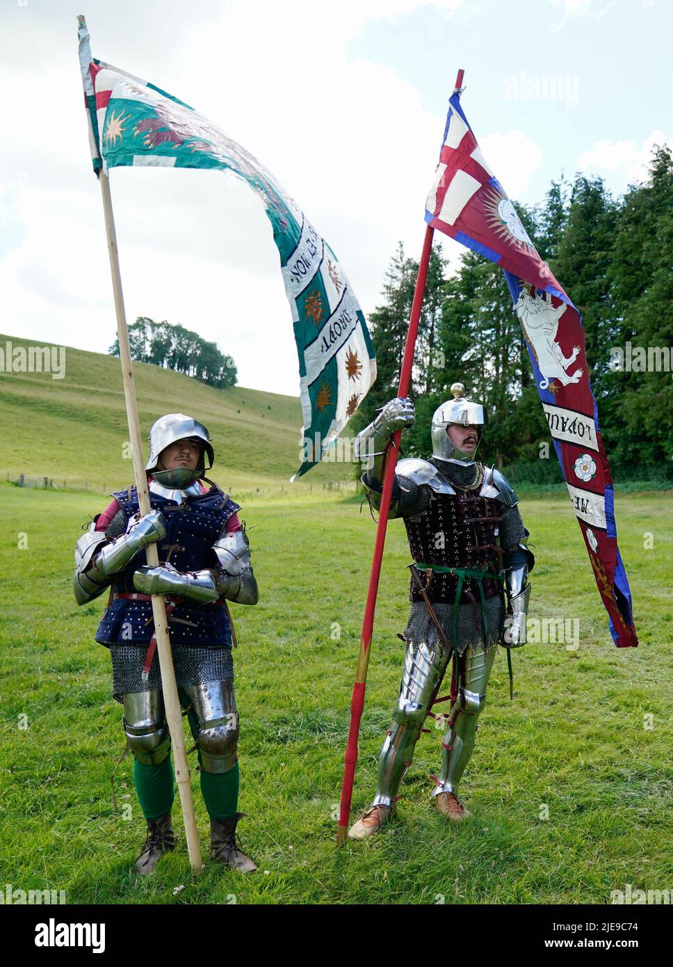 Two War of the Roses era re-enactors acting as standard bearers in the arena prior to giving a demonstration during the Chalke Valley History festival at Broad Chalke, Near Salisbury, Wiltshire. Picture date: Sunday June 26, 2022. Stock Photo