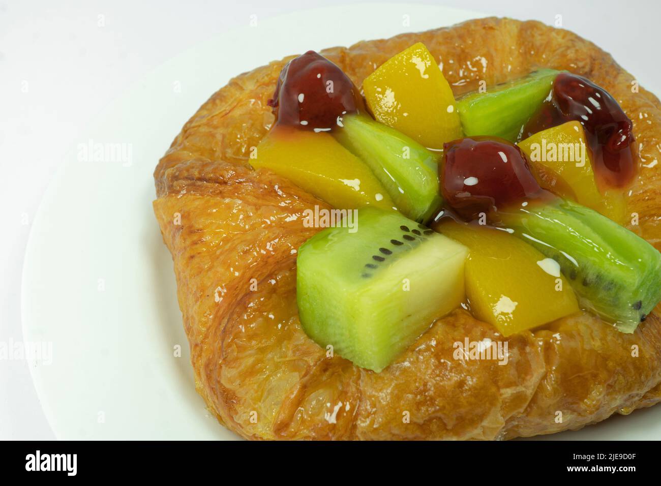 Closed up of Danish pastry with fruits isolated on white background Stock Photo