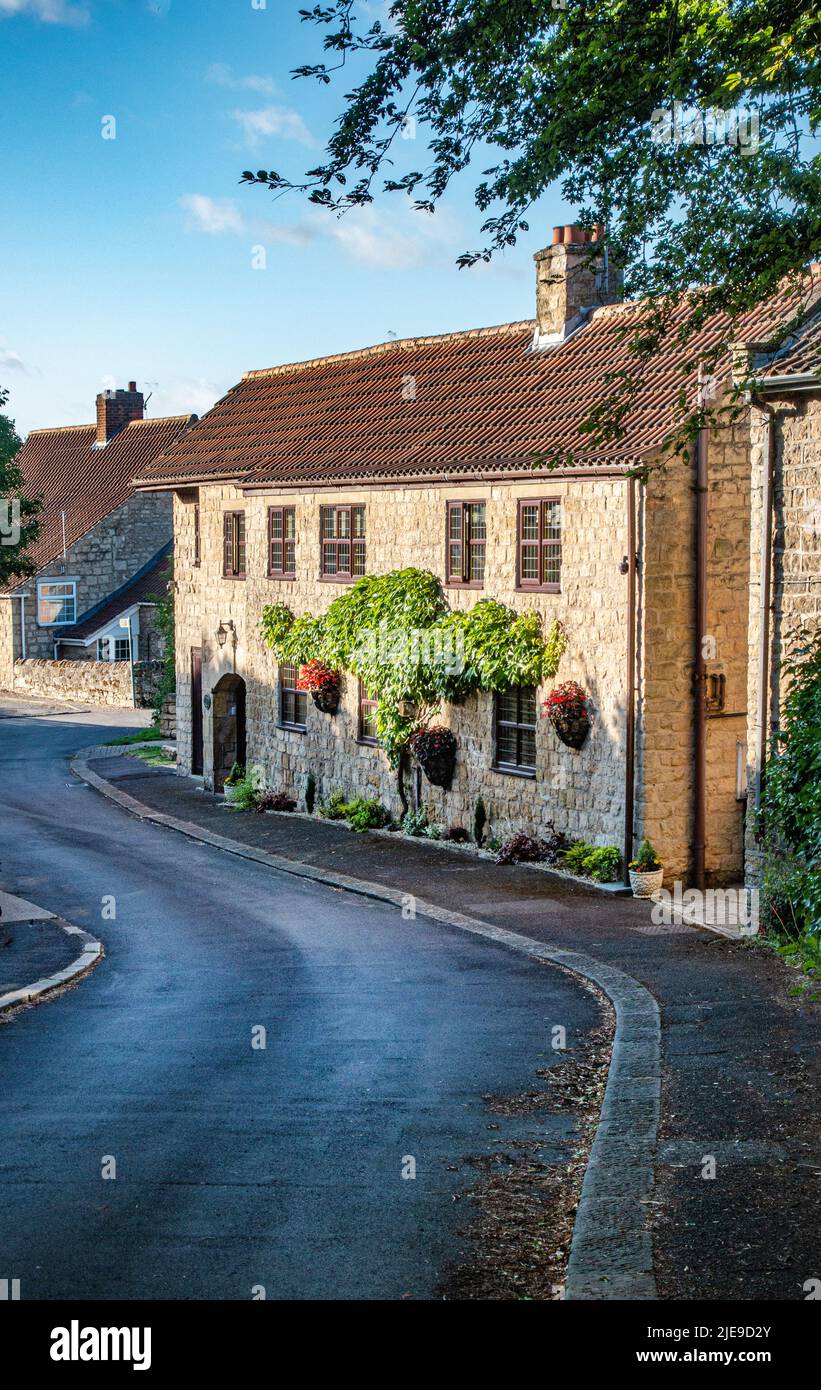 Pretty detached stone cottage in a sunny village Stock Photo