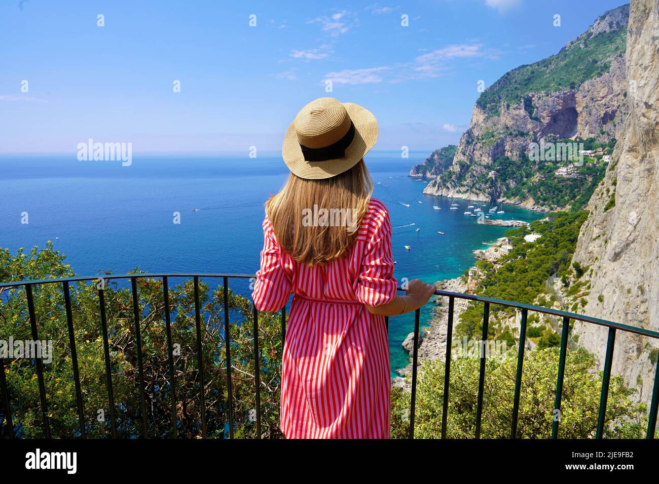 Tourism in Capri, Italy. Young beautiful fashion woman enjoying stunning landscape on Capri Island, Italy. Stock Photo