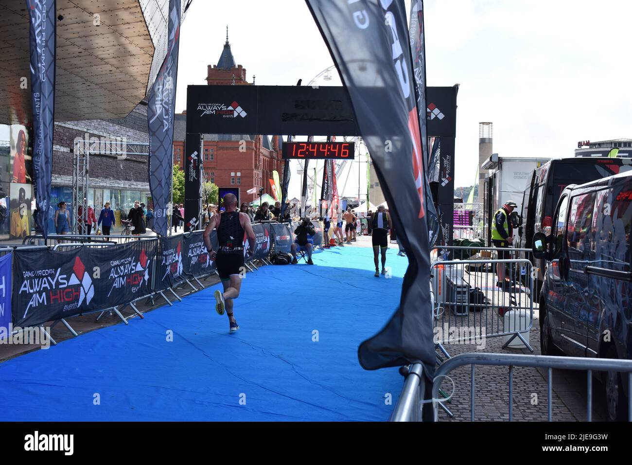 Cardiff Triathlon, Cardiff, Wales, 26th June 2022. Competitor runs towards the finish line of the Cardiff Triathlon, Cardiff Bay. Credit Tiffany Lacey / Alamy Live News Stock Photo