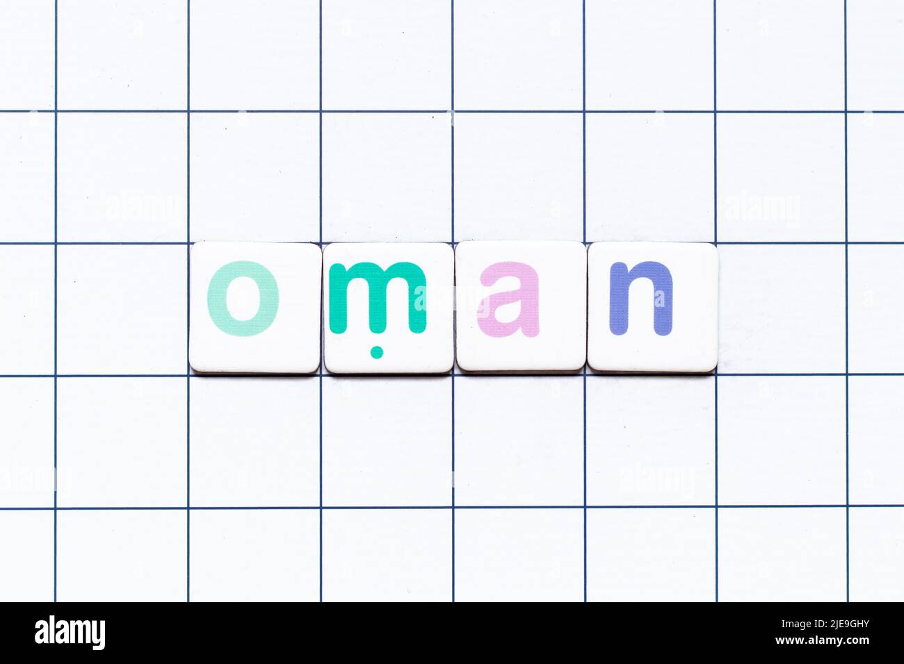 Colorful tile letter in word oman on white grid background Stock Photo