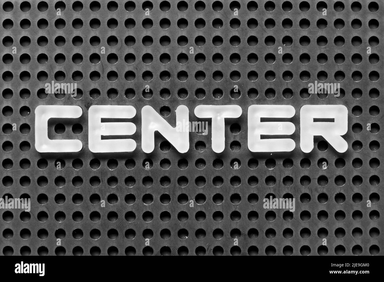 White alphabet letter in word center on black pegboard background Stock Photo Alamy