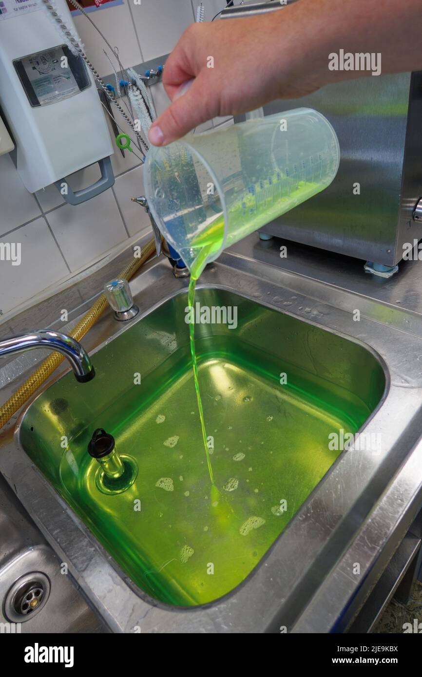 a neon green liquid is put into a water bath Stock Photo Alamy