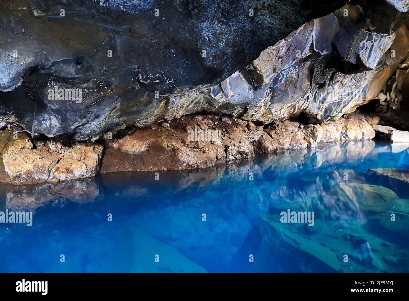 View into Grjotagja lava cave with crystal clear blue water Stock Photo