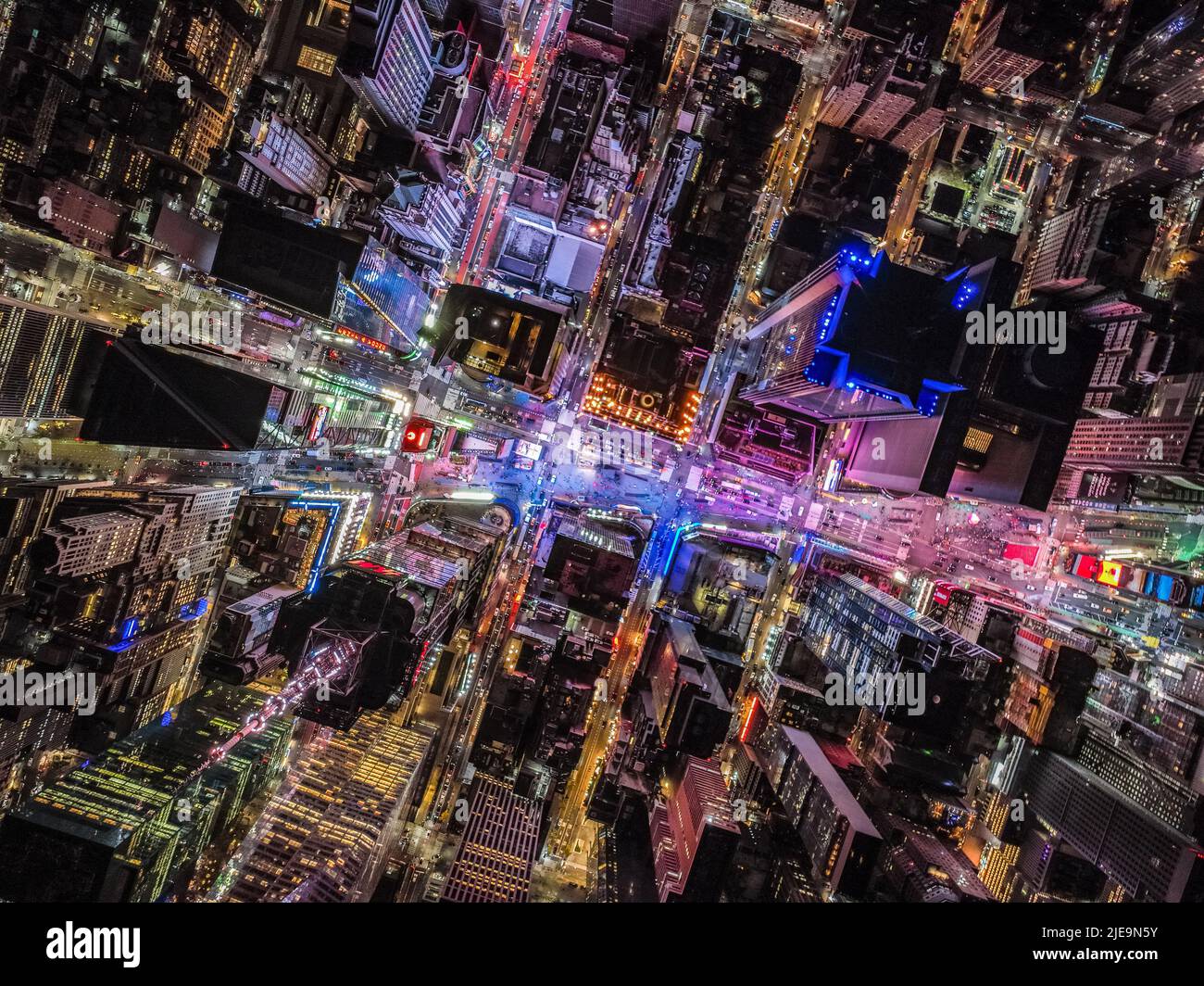 Overhead shot of buildings and streets around Times Square. Advertisements and displays glowing colourful light. Manhattan, New York City, USA Stock Photo