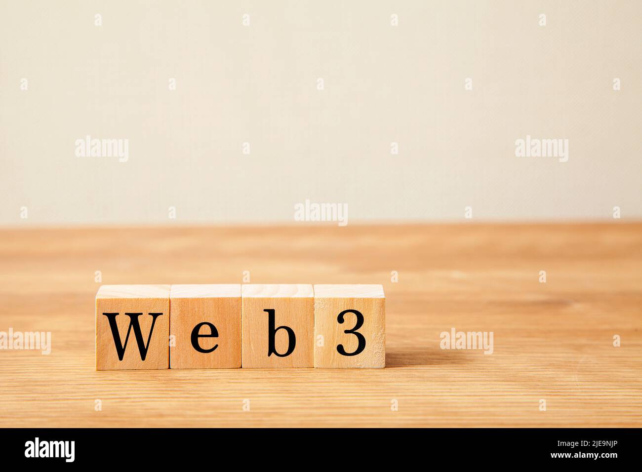 web3 characters. Written on four wooden blocks. Black letters. Wooden table background. Stock Photo