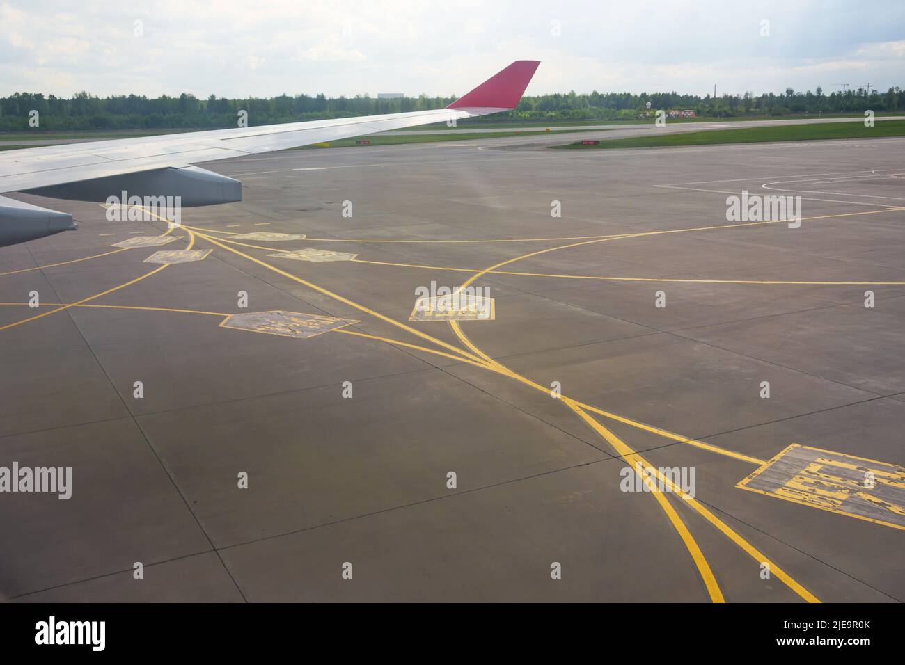 Airport yellow taxiway lines markings on the apron on concrete asphalt, sign for airplane pilots Stock Photo