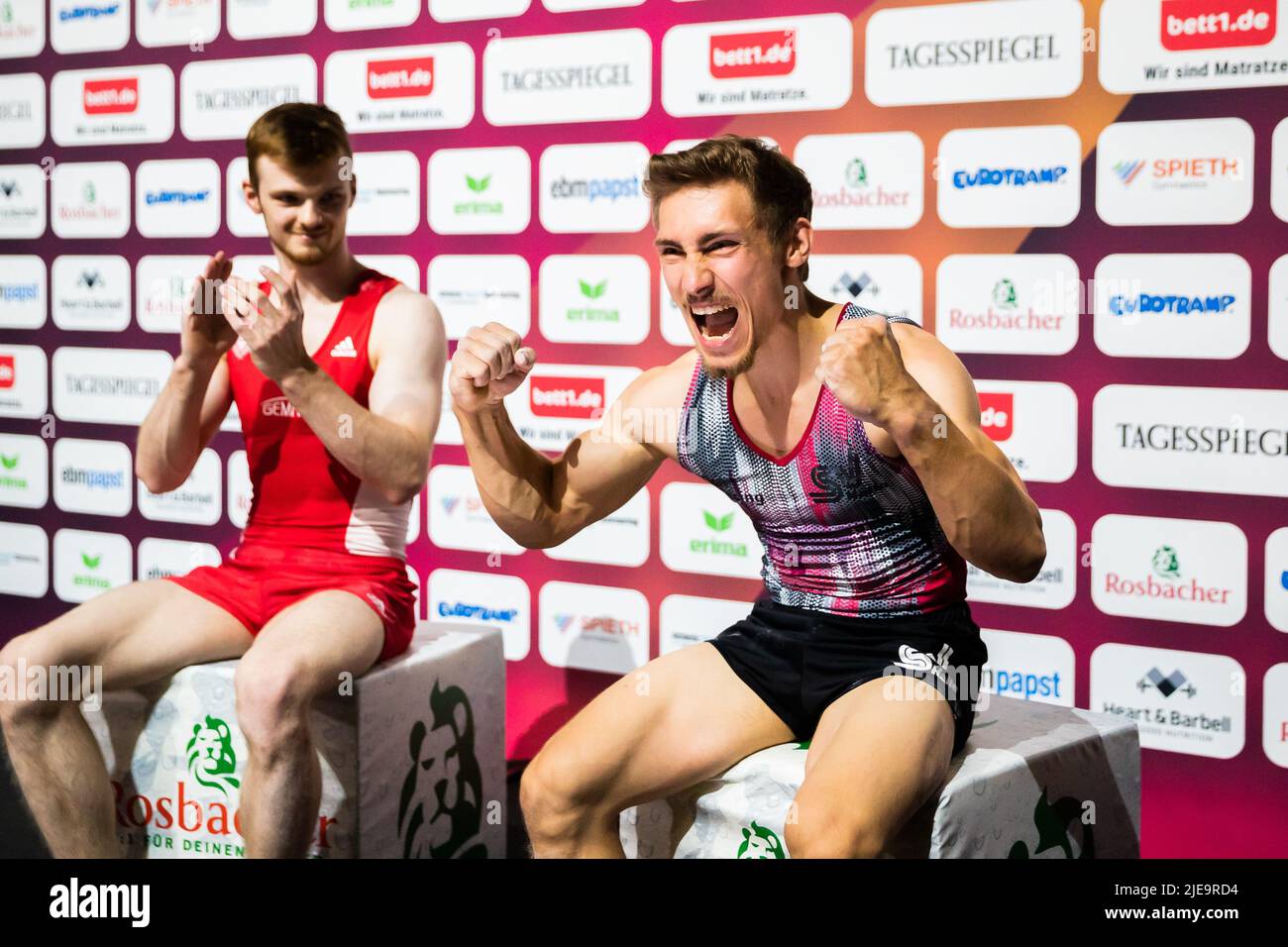 Berlin, Germany. 26th June, 2022. Gymnastics: German Championships, apparatus finals 2 men, vault. Nick Klessing (r) is happy about the 1st place next to Leonard Prügel. Credit: Christoph Soeder/dpa/Alamy Live News Stock Photo