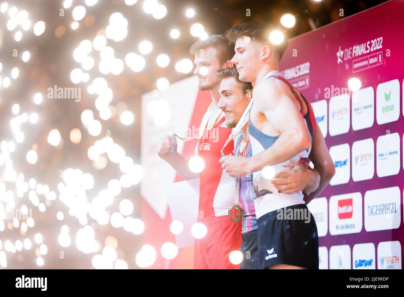 Berlin, Germany. 26th June, 2022. Gymnastics: German Championships, apparatus finals 2 men, vault. Leonard Prügel (2nd place, l-r), Nick Klessing (1st place) and Dario Sissakis (3rd place) at the award ceremony. Credit: Christoph Soeder/dpa/Alamy Live News Stock Photo