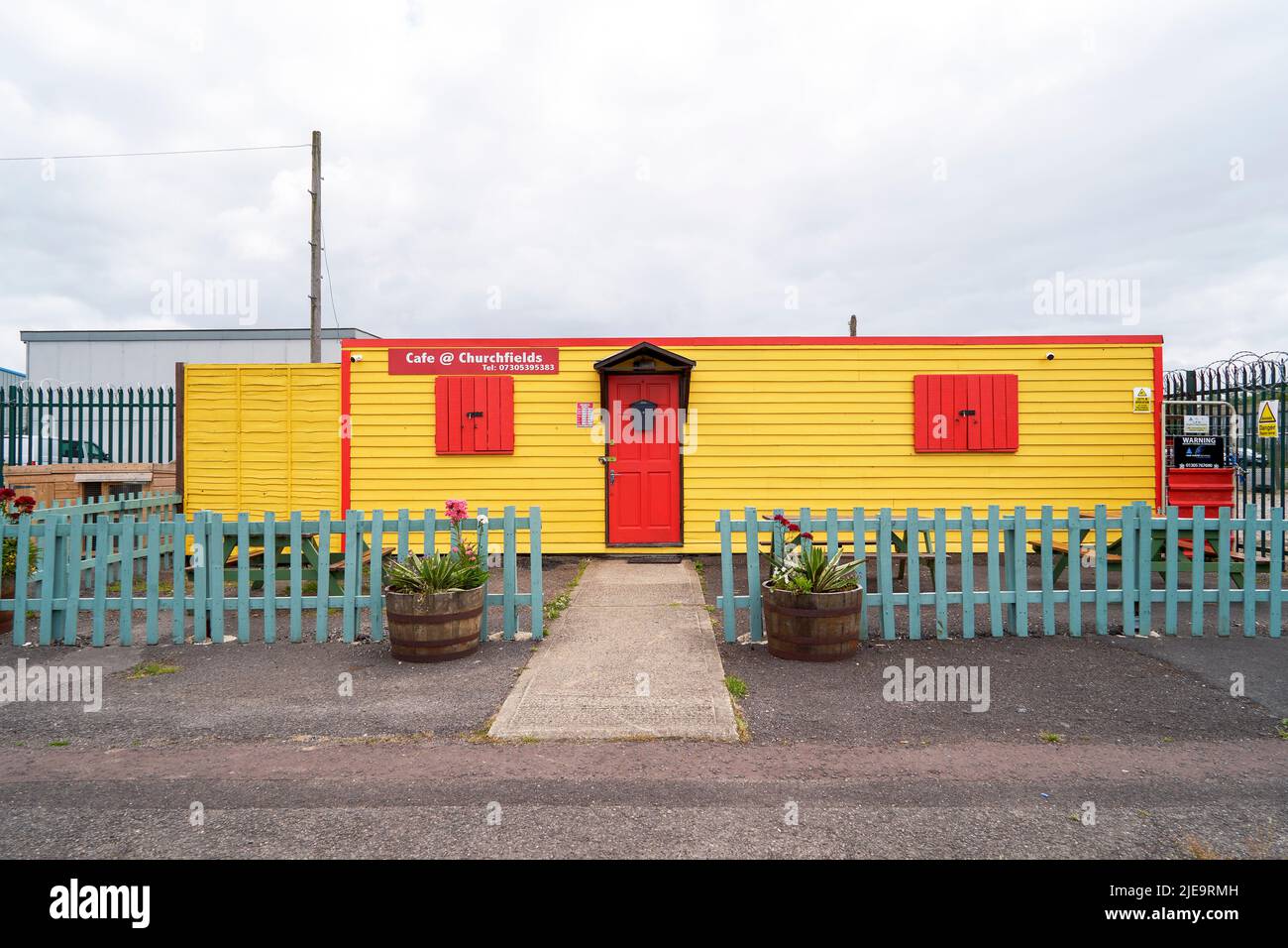 Brightly painted yellow and red wooden structure cafe Stock Photo