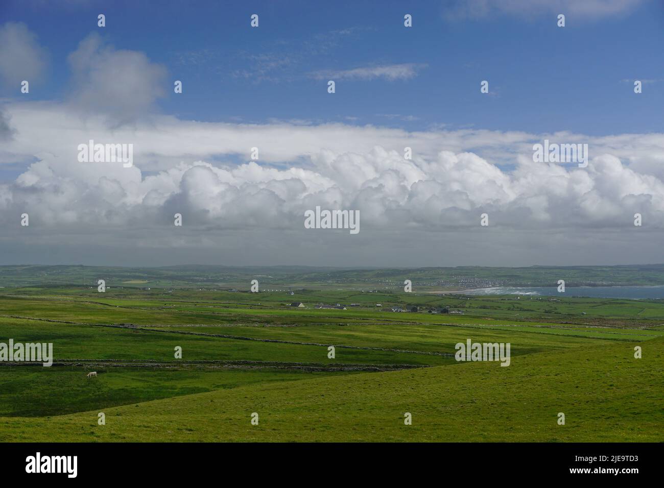 Lahinch, Co. Clare, Ireland: Green fields and farms in County Clare, Ireland, with a view of Lahinch and Liscannor Bay in the distance. Stock Photo