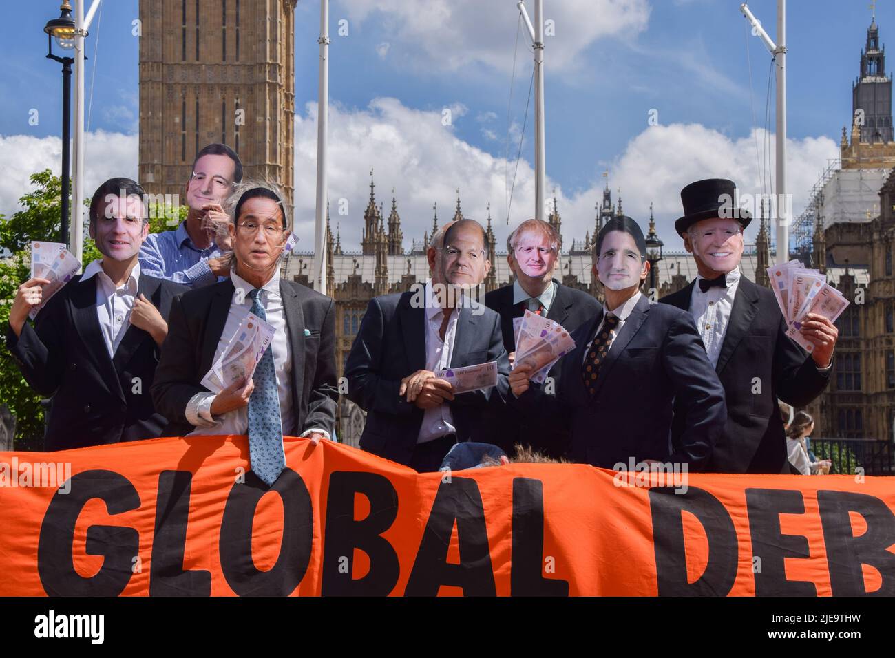 London, UK. 26th June 2022. Extinction Rebellion activists dressed as G7 leaders Emmanuel Macron, Mario Draghi, Fumio Kishida, Olaf Scholz, Boris Johnson, Justin Trudeau and Joe Biden. The action was part of the day’s protest demanding that the G7 cancels the debt of the countries in the Global South, which is forcing the nations to extract fossil fuels to pay off the debts. Credit: Vuk Valcic/Alamy Live News Stock Photo