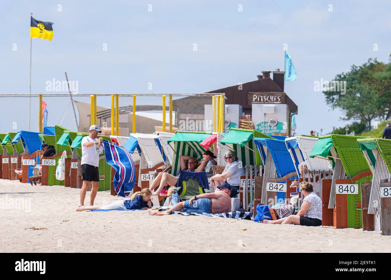 Tourists in colorful beach chairs on the beach sunbathing on Juni 21 ...