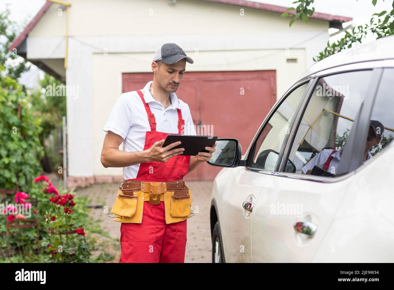 mechanic using digital tablet in workshop Stock Photo