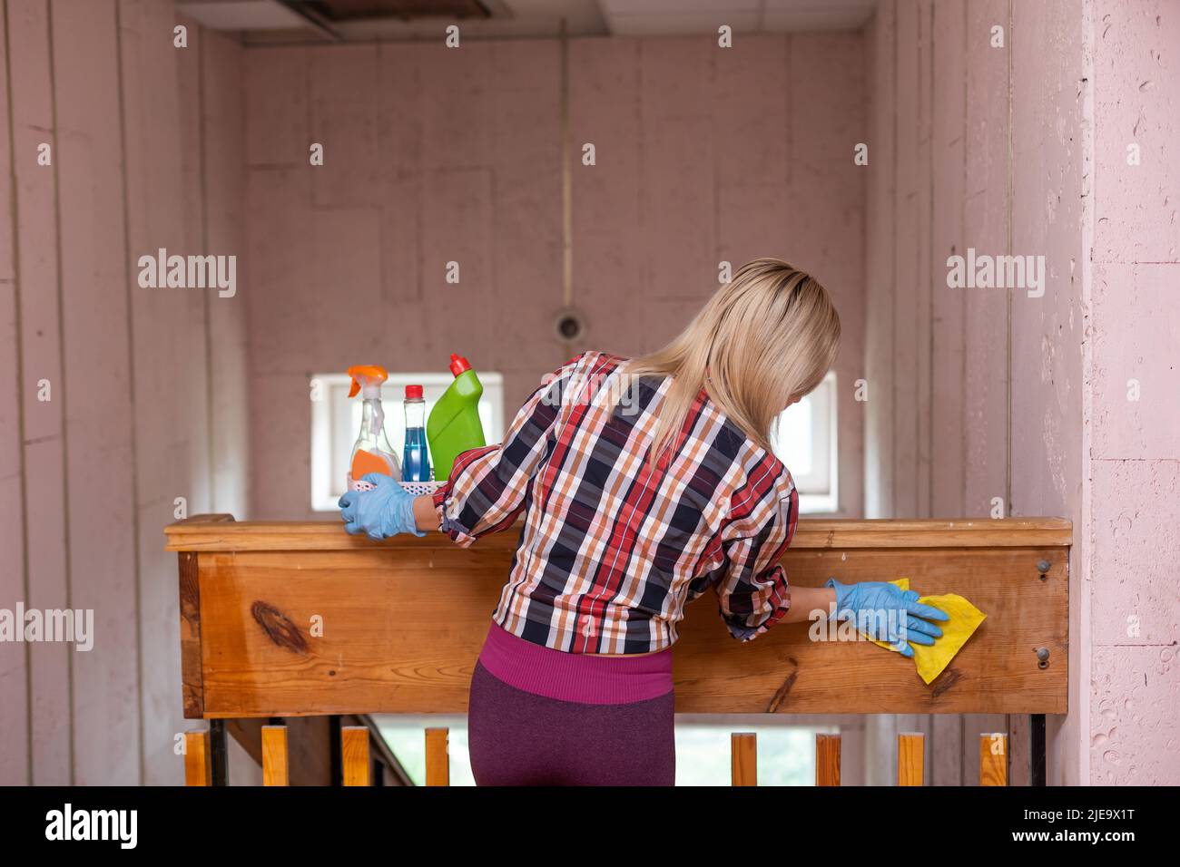 Woman cleaning and wiping with microfiber cloth. Woman doing chores at