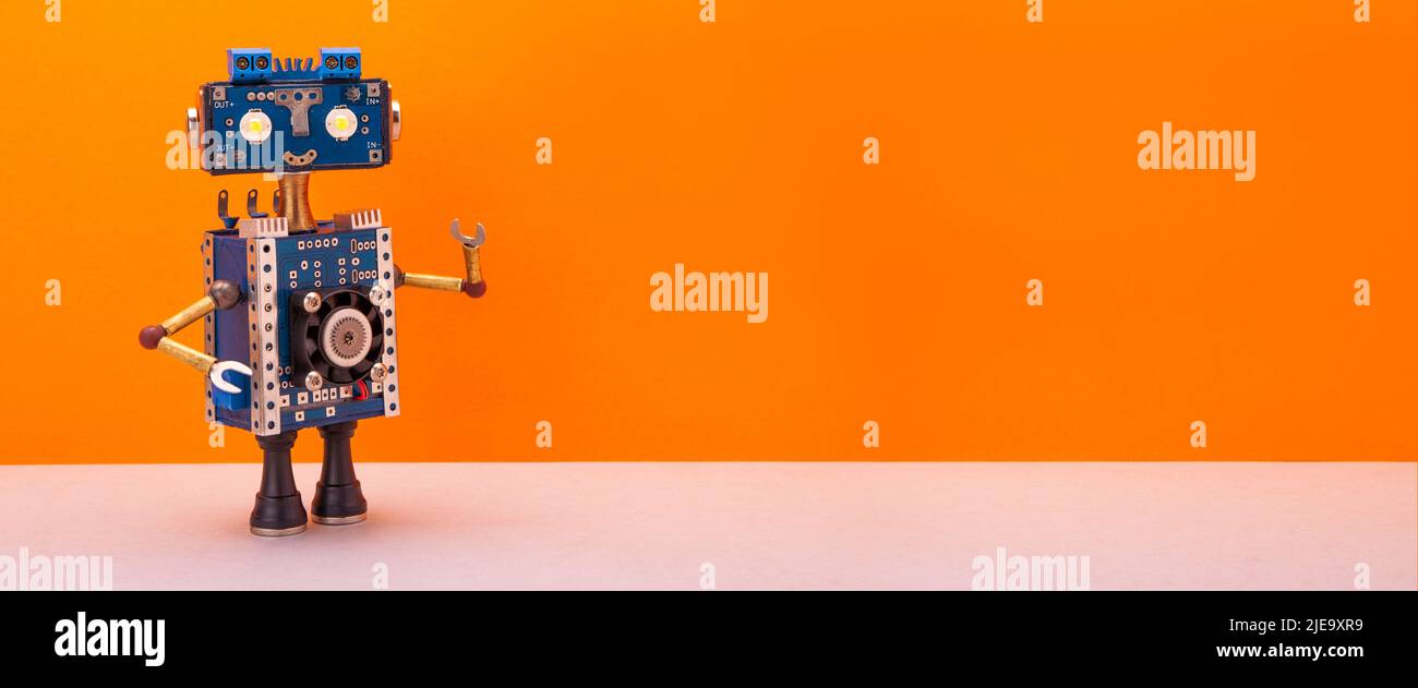 A kind smiling toy, steampunk mechanical robot, technology robotic poster template with place for text and design. orange, beige copy space Stock Photo