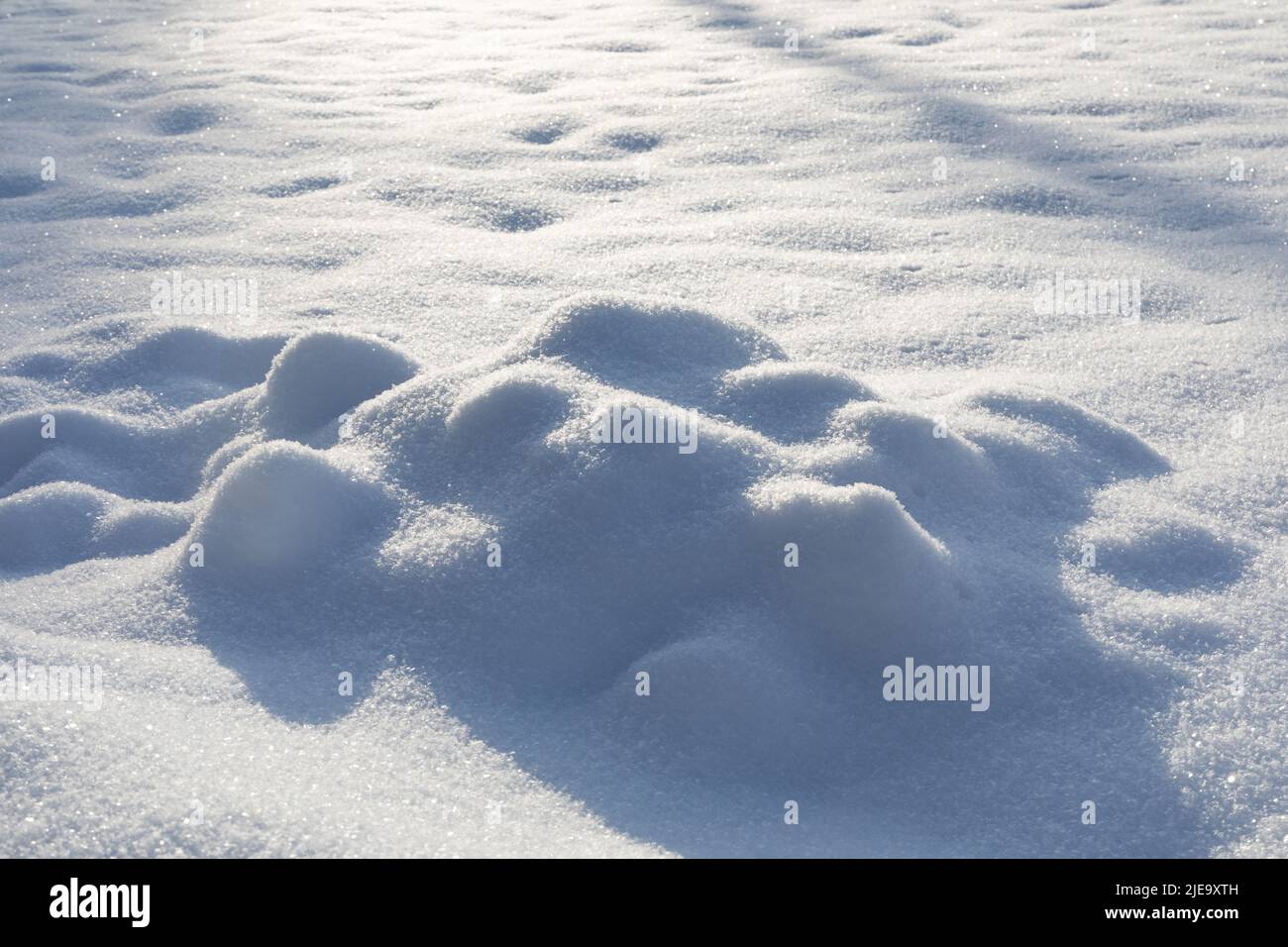 Snow texture background with shadows. Winter season decorative nature frame. Ground surface covered crystal snowflakes after snowfall Stock Photo