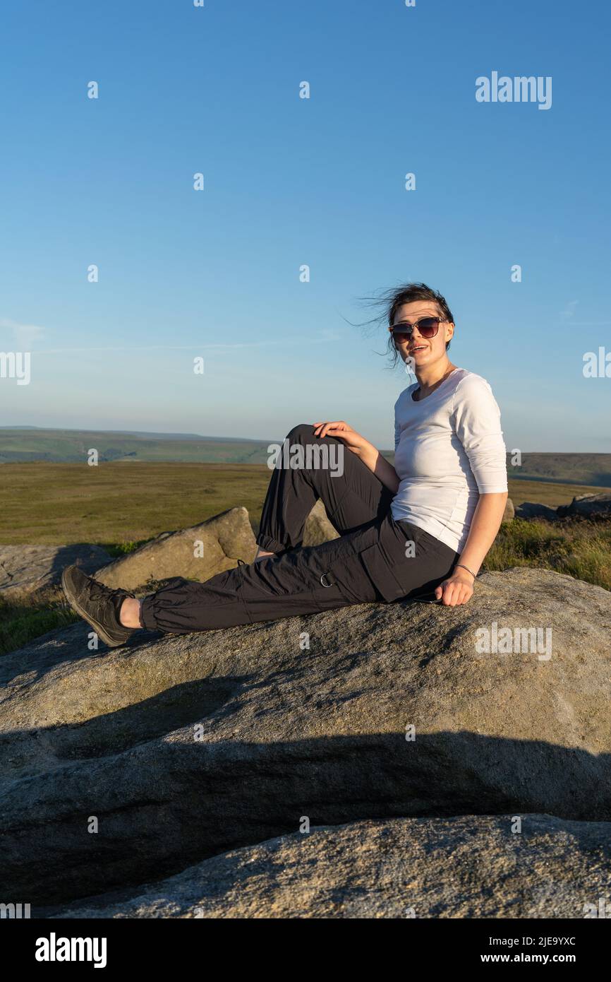 Girl sitting on the rock hi-res stock photography and images - Alamy