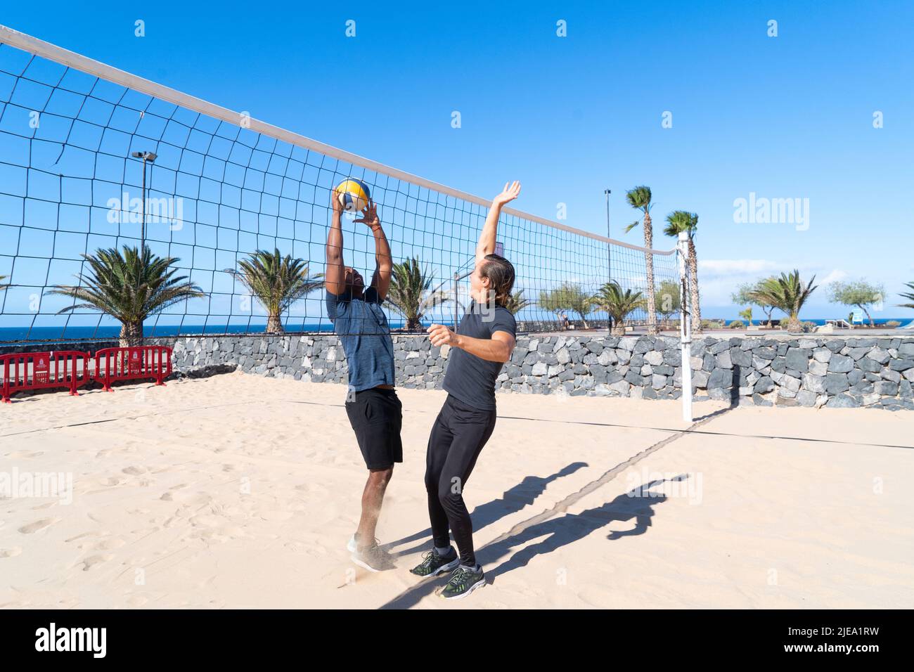 happy man playing beach volleyball Stock Photo Alamy