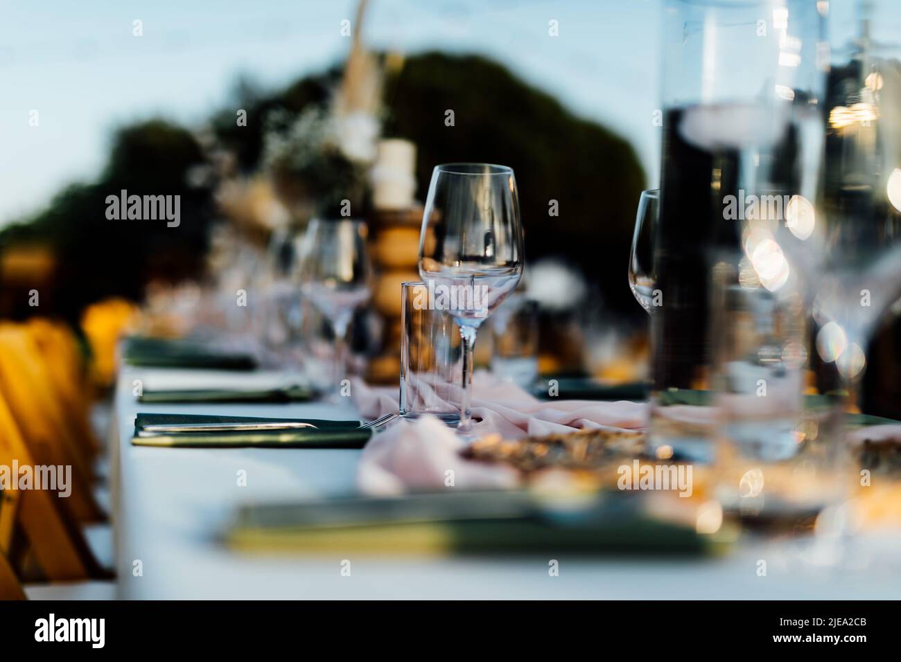 Luxury table settings for fine dining with and glassware, pouring wine