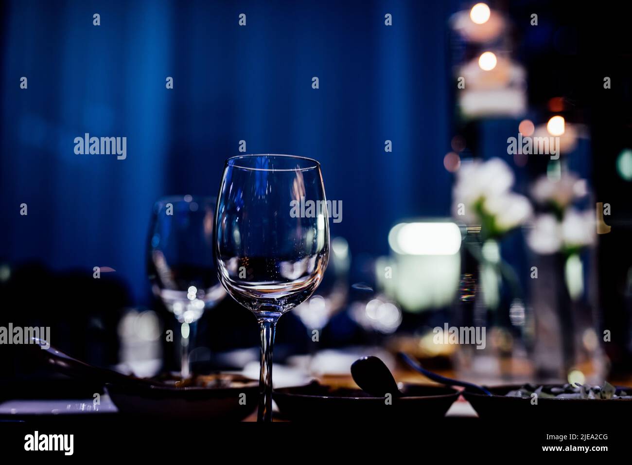 Luxury table settings for fine dining with and glassware, pouring wine to glass. Beautiful
