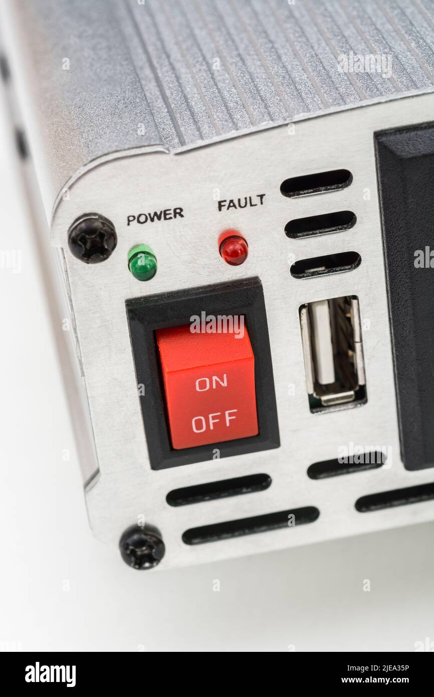1500w / Watt DC to AC inverter unit made in China. Red On-Off switch and 3-pin AC power plug socket visible, along with USB charging point socket. Stock Photo