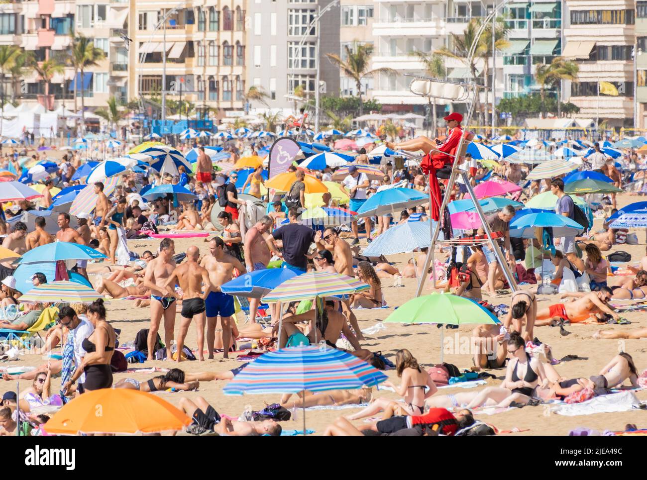 Las Palmas, Gran Canaria, Canary Islands, Spain. 26th June, 2022. Tourists, many from the UK, bask on the city beach in Las Palmas on Gran Canaria. Credit: Alan Dawson/ Alamy Live News. Stock Photo