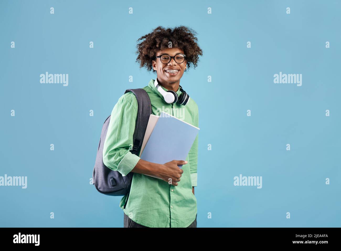 Smart african american student guy with backpack and notebooks smiling ...