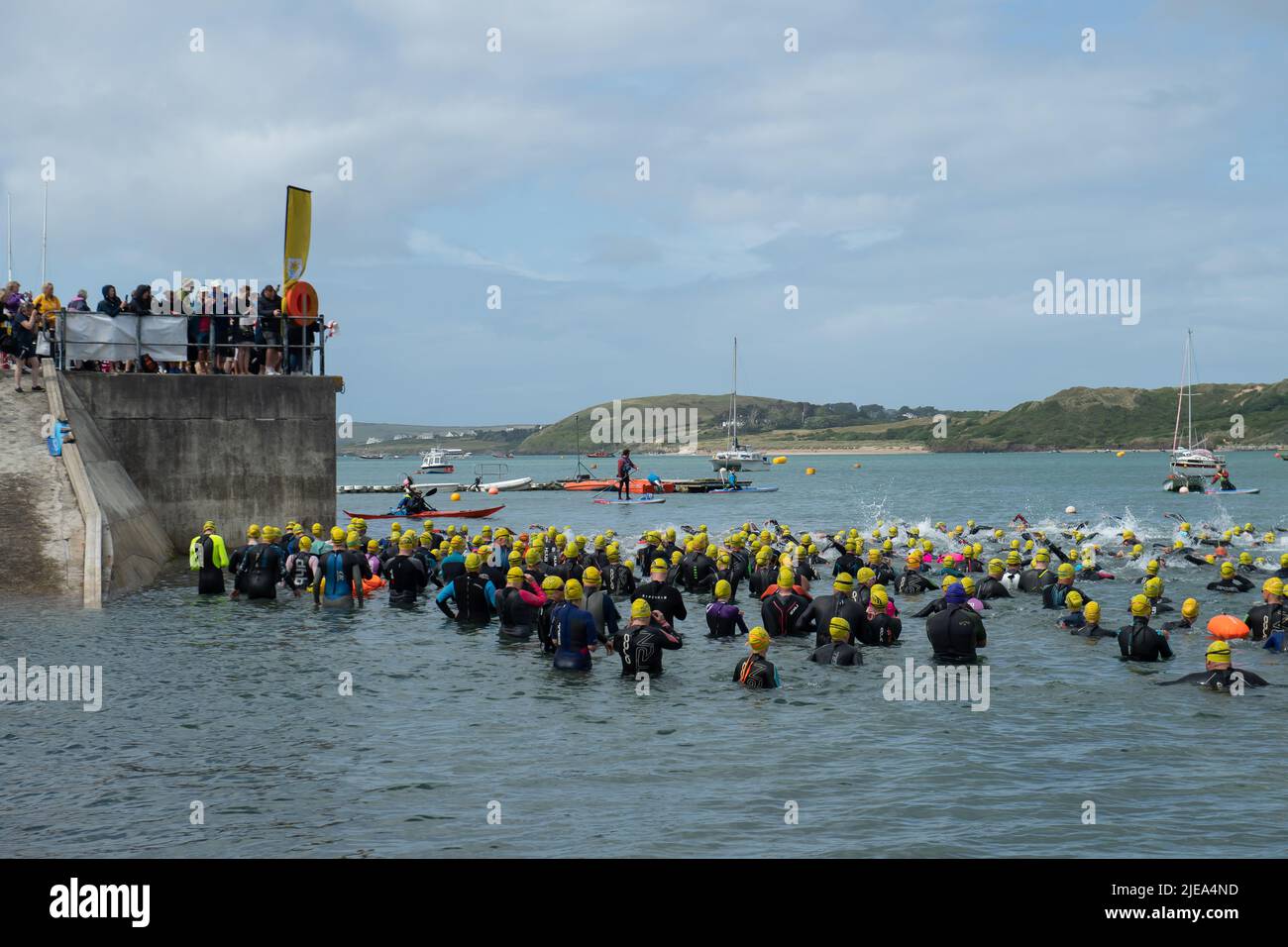 Padstow, Cornwall, UK. 26th June, 2022. Swimmers take to the sea to raise funds for The Marie Curie Nursing Services in Cornwall by swimming from Padstow to Rock: Credit: Ashley Western/Alamy Live News Stock Photo