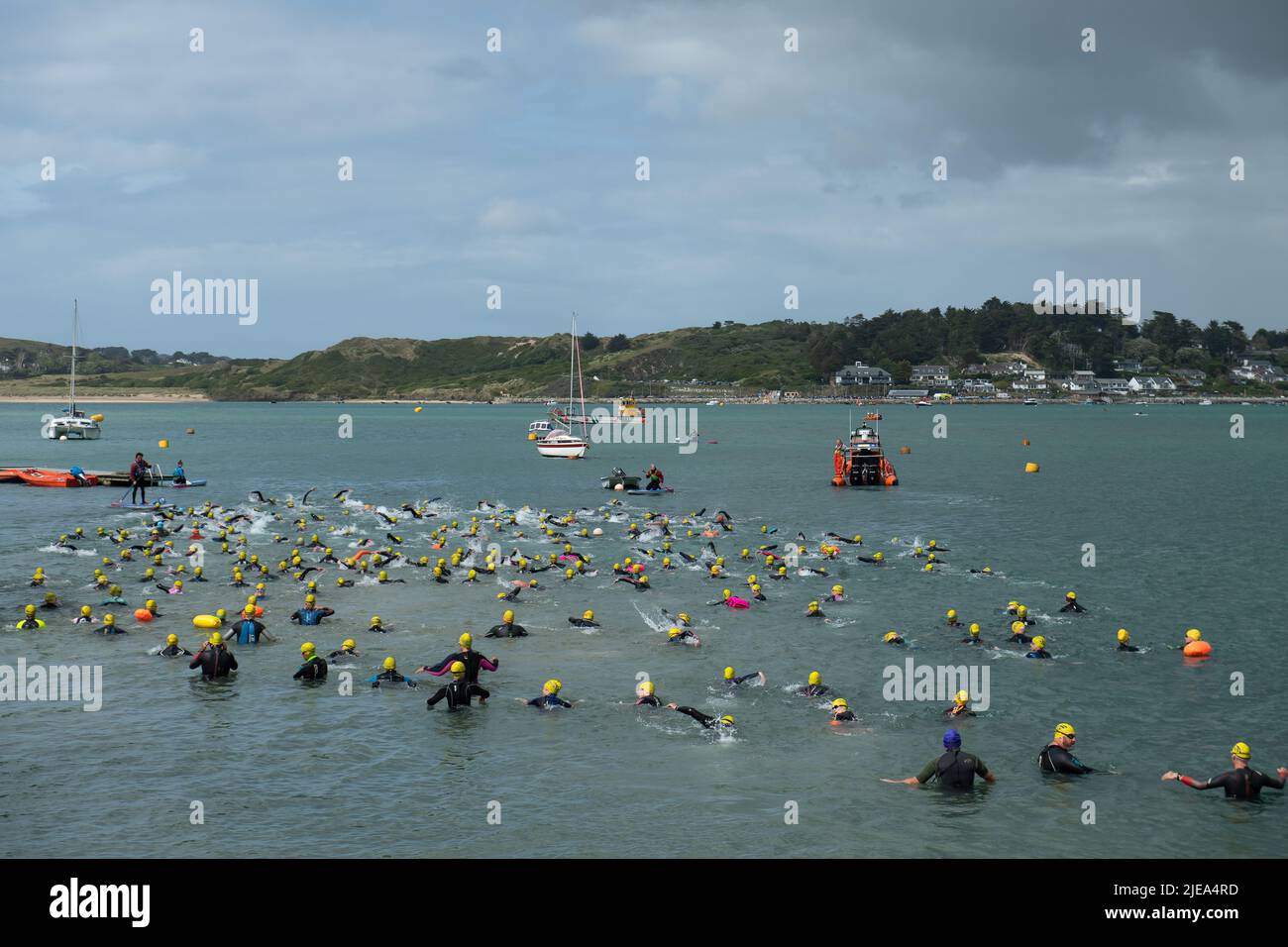 Padstow, Cornwall, UK. 26th June, 2022. Swimmers take to the sea to raise funds for The Marie Curie Nursing Services in Cornwall by swimming from Padstow to Rock: Credit: Ashley Western/Alamy Live News Stock Photo