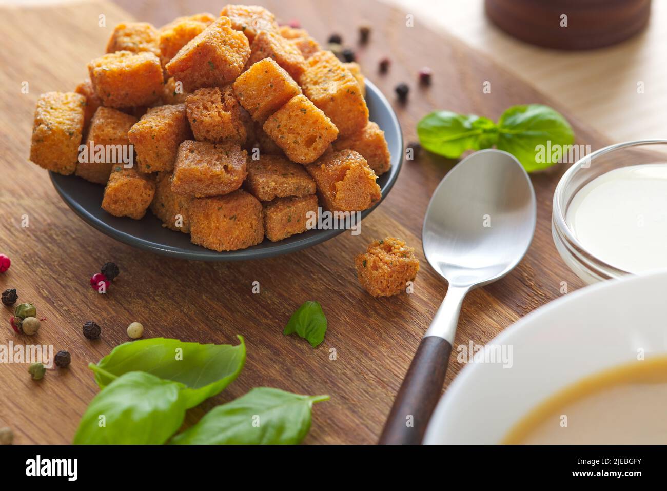 Plate with soup croutons and herbs - close up view Stock Photo